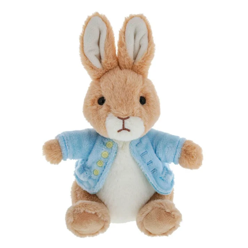 Plush toy rabbit wearing a blue coat on a white background