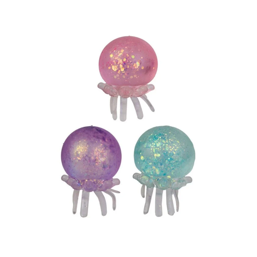 Three jellyfish-shaped resin jewelry findings on a white background, featuring one pink, one purple, and one light blue jellyfish with glittery interiors and translucent tentacles.