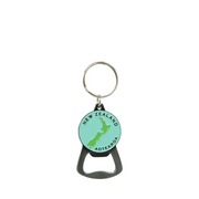 A bottle opener keychain featuring a circular mint green charm with a green silhouette of New Zealand and the text 'NEW ZEALAND AOTEAROA', attached to a black bottle opener and silver split ring, on a light gray background.