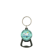 A bottle opener keychain with a circular light blue and white camping trailer graphic on a light gray background.
