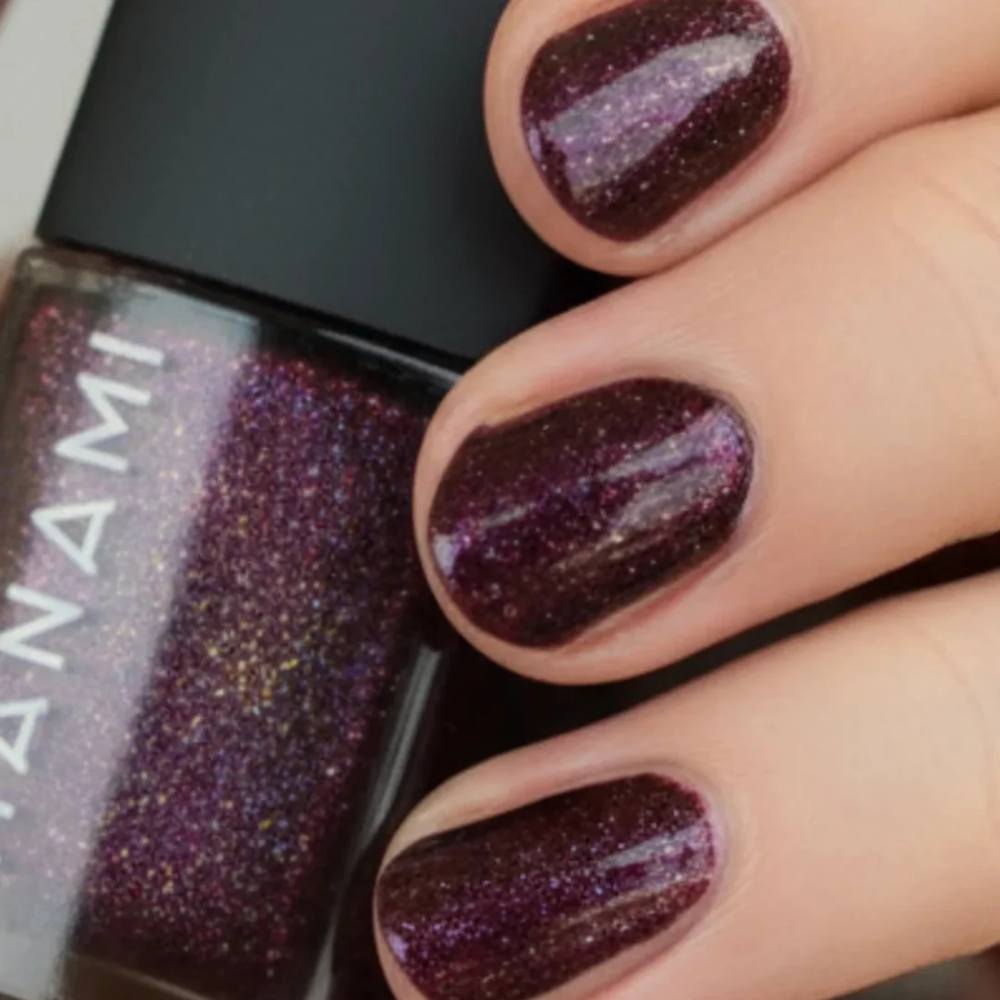 Nail polish with glittery purple finish and 'Yanami' branding.