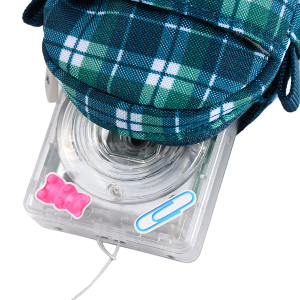 Clear camera with green plaid case and decorative stickers on a white background