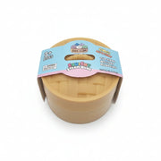 A toy steam-bake set in a round plastic container with a blue and pink paper label, photographed on a plain light gray background.