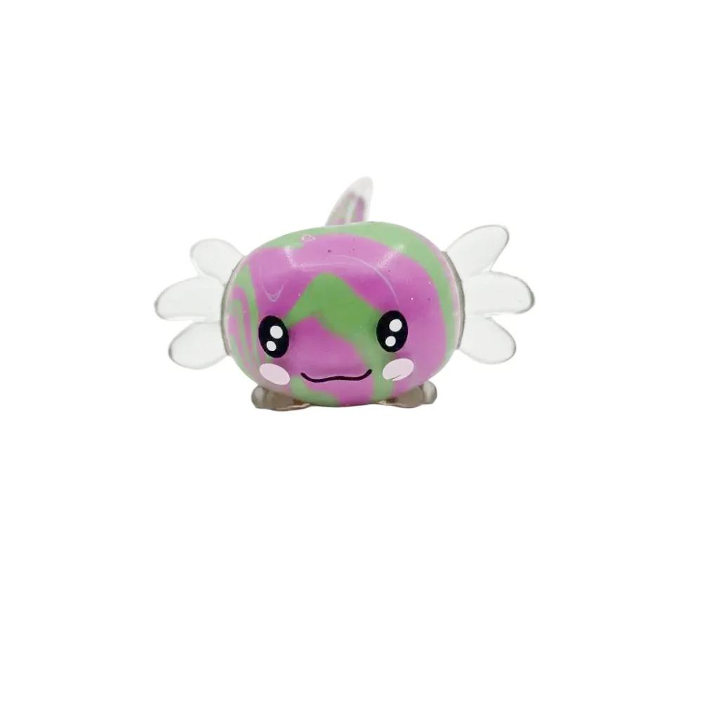 A small, cute, egg-shaped character bead or figurine with a purple and green marbled pattern, cartoon eyes, and clear wings, resting on a neutral gray background.