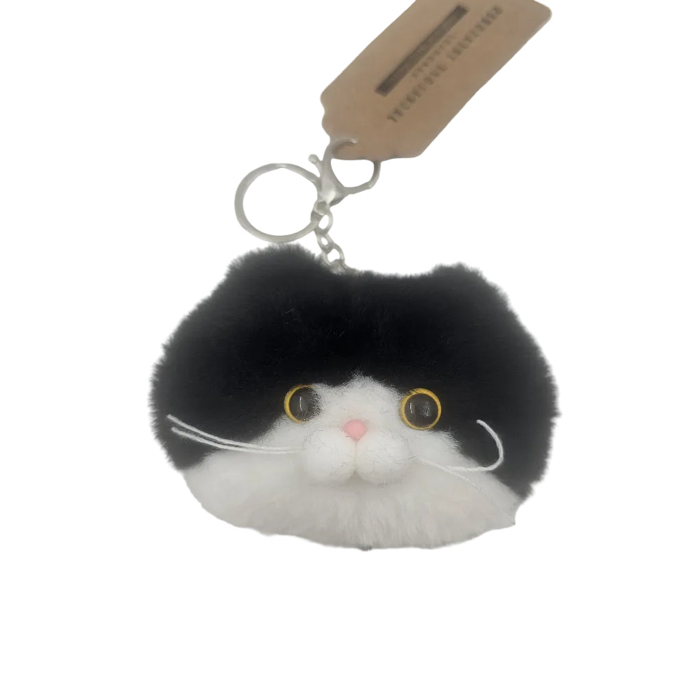 A black and white cat face bag charm