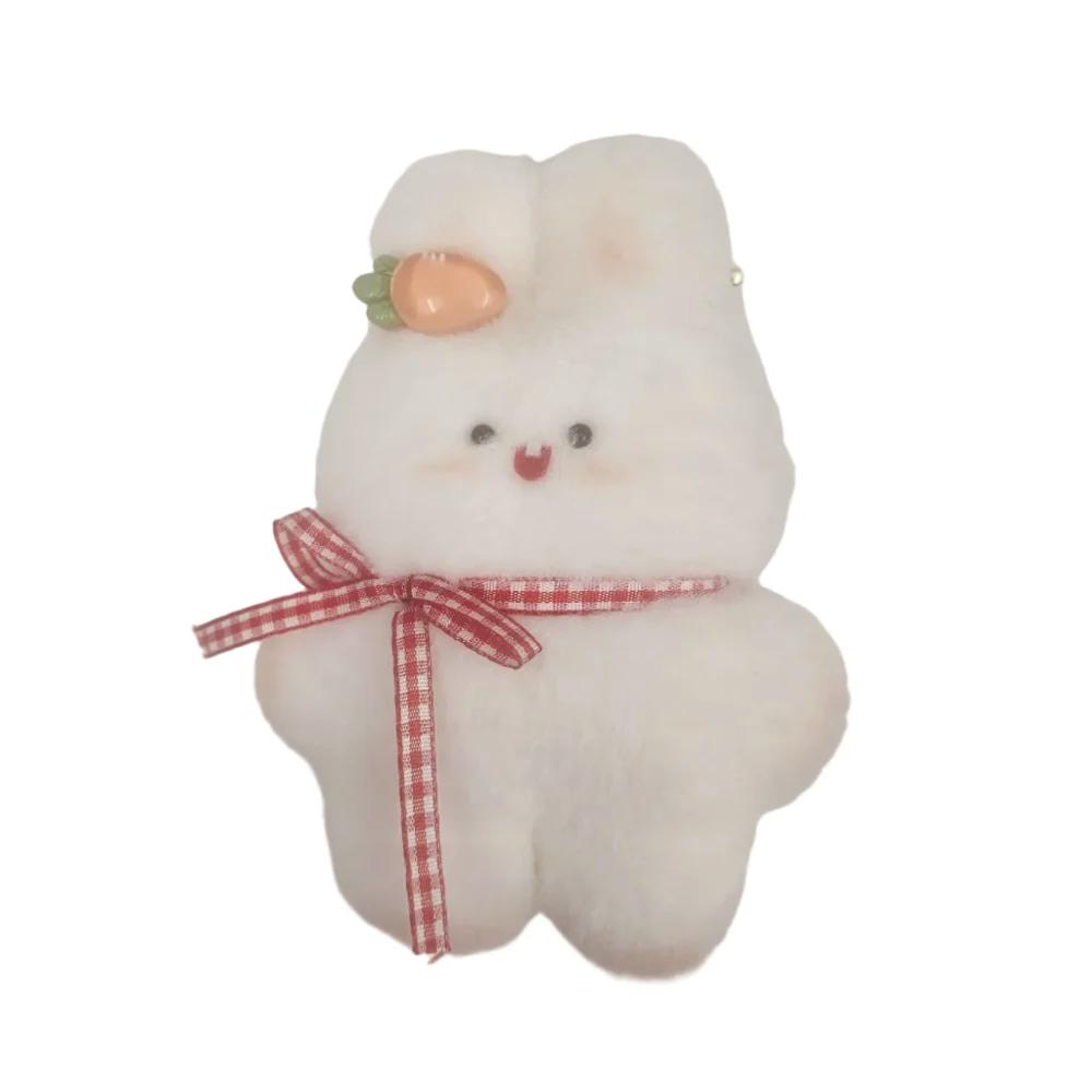 A white fluffy plush bunny accessory with a red and white gingham ribbon bow around its neck and a small peach-colored carrot accent on its head, shown against a plain light background.