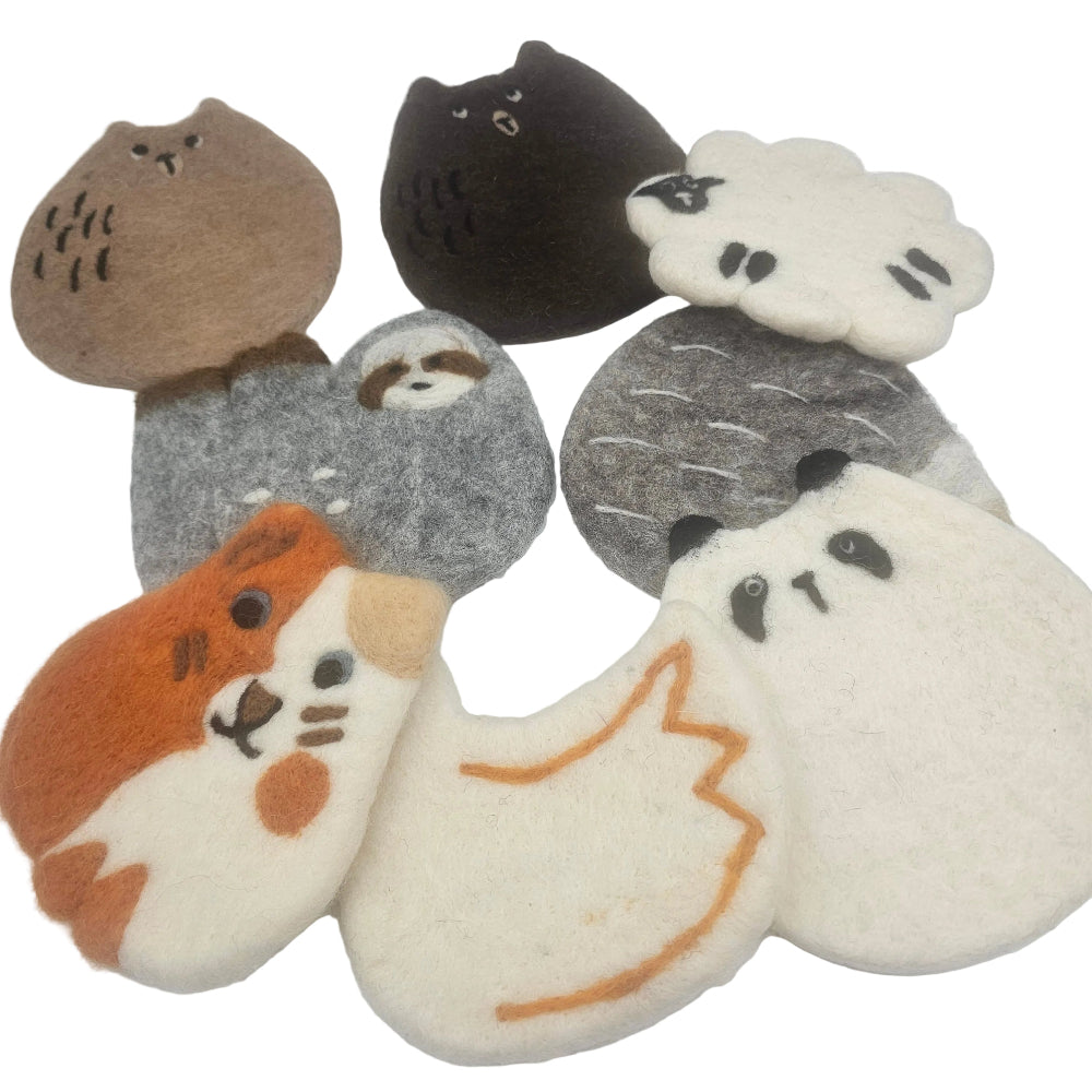 A set of cute, handcrafted felt animal coasters arranged on a plain white background. The coasters feature different animal faces and bodies in various colors including brown, black, white, gray, orange, and cream.
