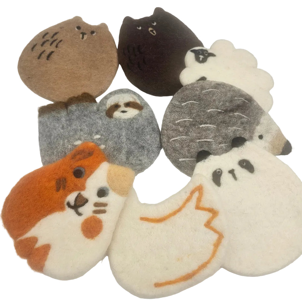 A set of seven felt animal and nature coasters arranged on a plain white background. The coasters feature cute animal designs including a brown owl, a dark brown cat, a white sheep, a gray sloth, a gray hedgehog, an orange and white hamster, and a white ghost with an orange outline.