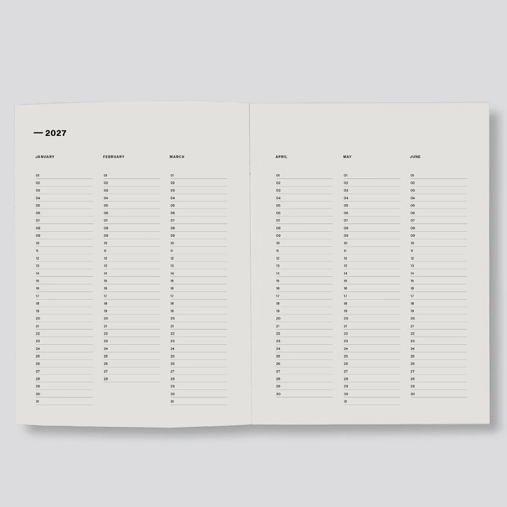 An open minimalist planner or calendar spread on a light gray background, showing blank monthly pages with columns for days of the week and the year 2027 at the top of the left page.