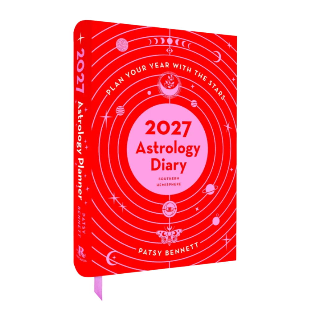 A red hardcover astrology planner titled '2027 Astrology Diary' by Patsy Bennett, featuring a pink central circle and white celestial illustrations on a white background.