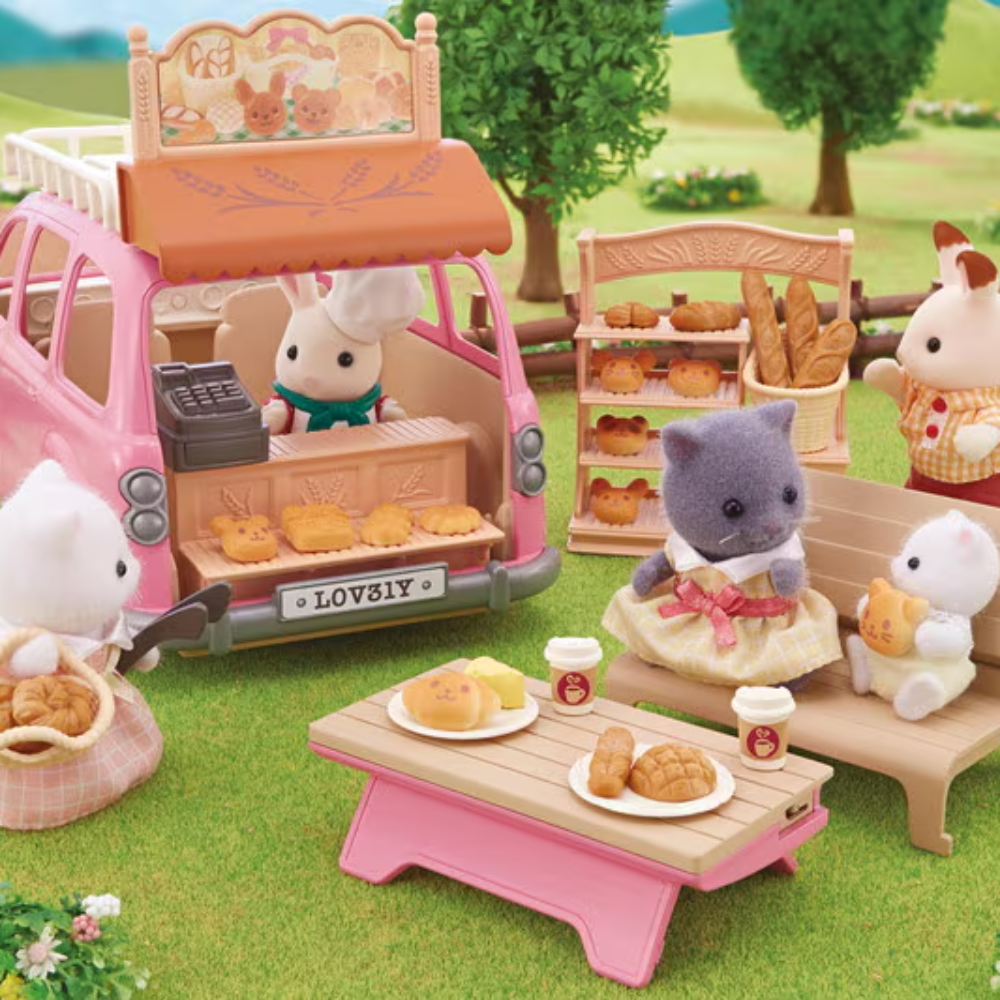 Toy set with a pink toy car, rabbits, and a cat in a garden setting.
