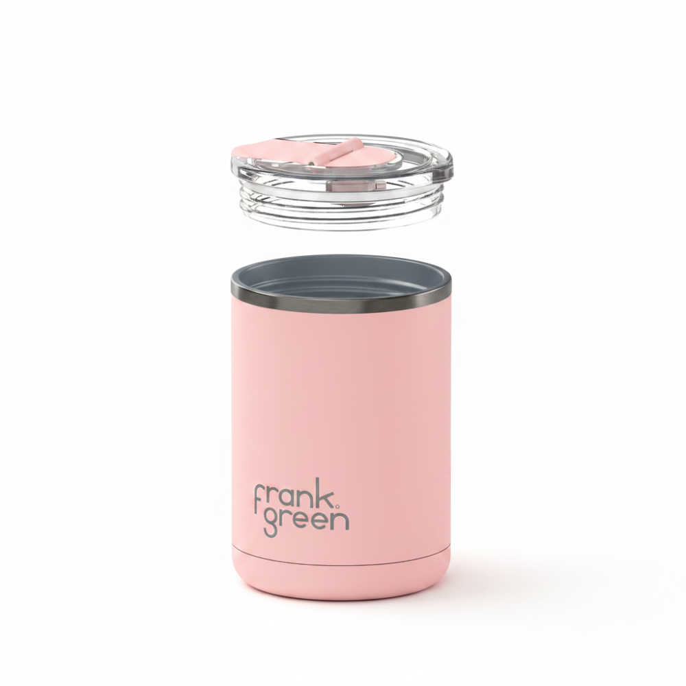 A pink insulated travel tumbler with a clear lid and a pink straw, shown floating against a solid white background. The brand name 'frank green' is printed in black on the lower front of the tumbler.