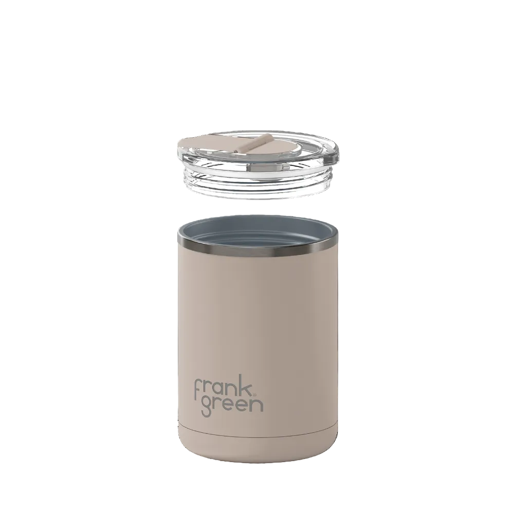 A Frank Green insulated travel tumbler in a warm taupe-beige color, shown with its clear lid floating above the rim against a solid white background.