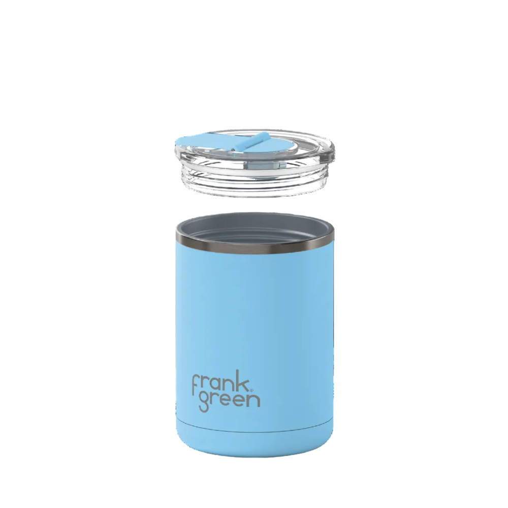 A light blue vacuum-insulated tumbler with a clear lid and blue insert, shown floating against a solid white background. The brand name 'frank green' is printed in brown on the lower front of the tumbler.