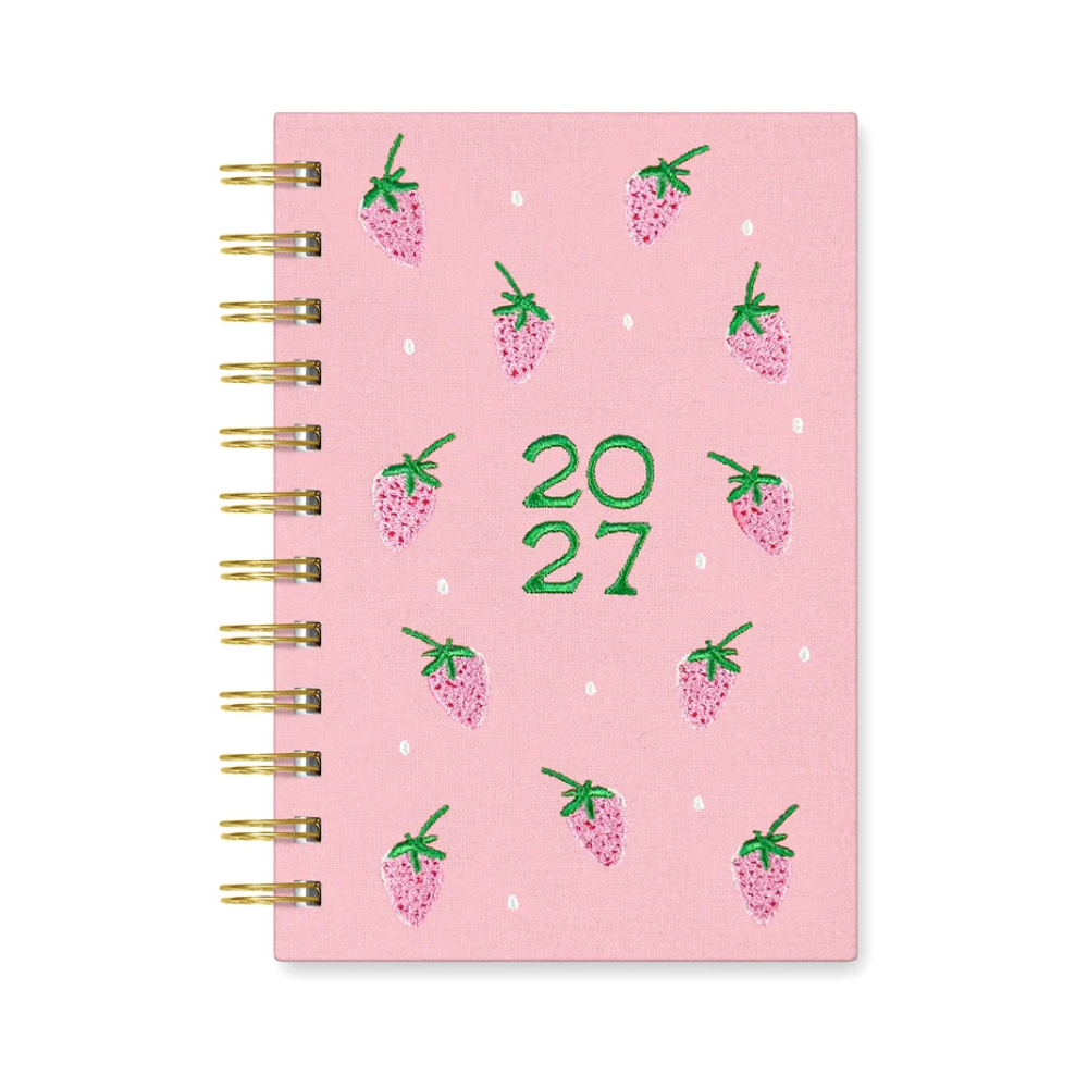 A pink spiral-bound planner or notebook with a strawberry pattern and the year '2027' in green on the cover, shown on a plain white background.