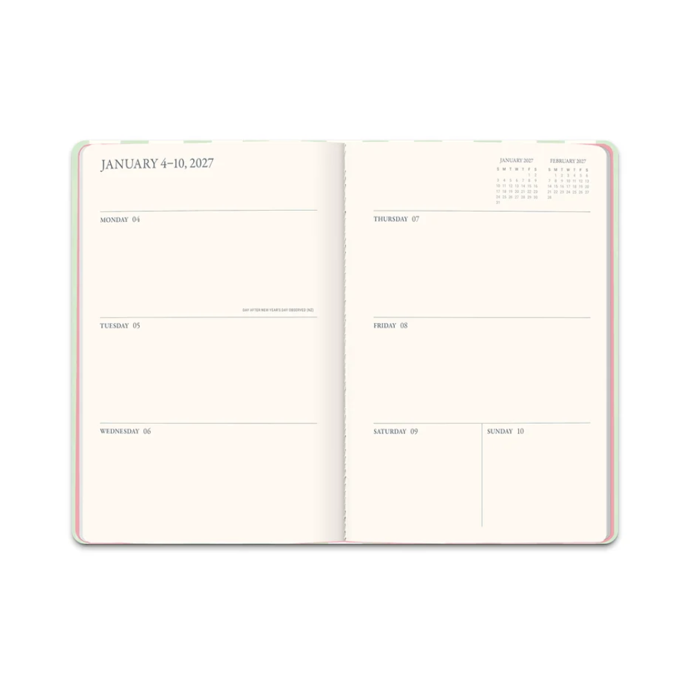 An open planner or calendar showing the interior pages for January 4-10, 2027, with daily time slots and a small monthly calendar at the top right. The pages are warm off-white with thin gray lines and text, and the notebook edges show a soft pastel multicolor design.