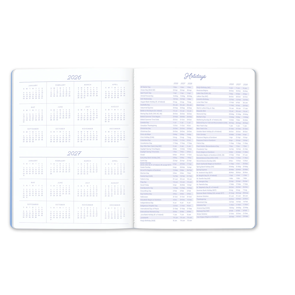 An open two-page planner spread showing the 2026 calendar on the left page and a holidays table on the right page, in white with light blue text and borders.