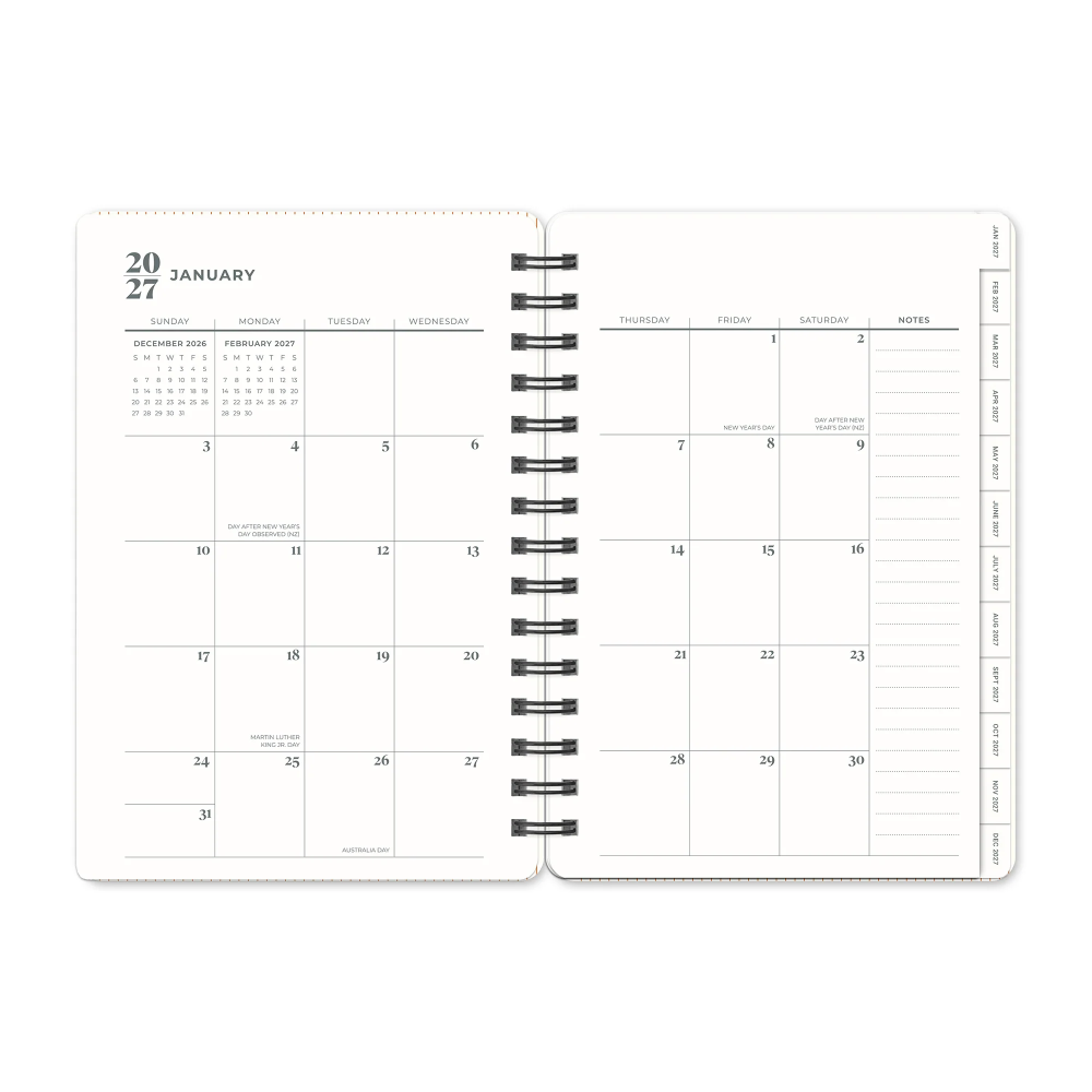 Spiral-bound planner with calendar and notes pages on a white background