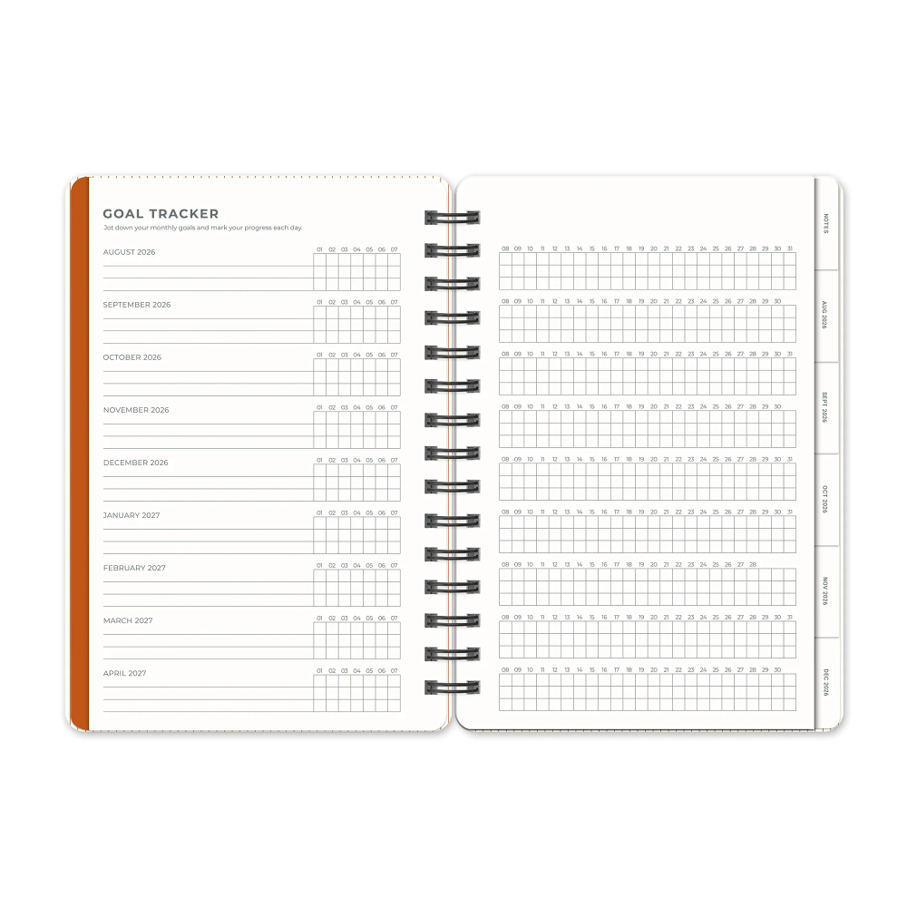 Spiral-bound planner with goal tracker and grid pages on a white background
