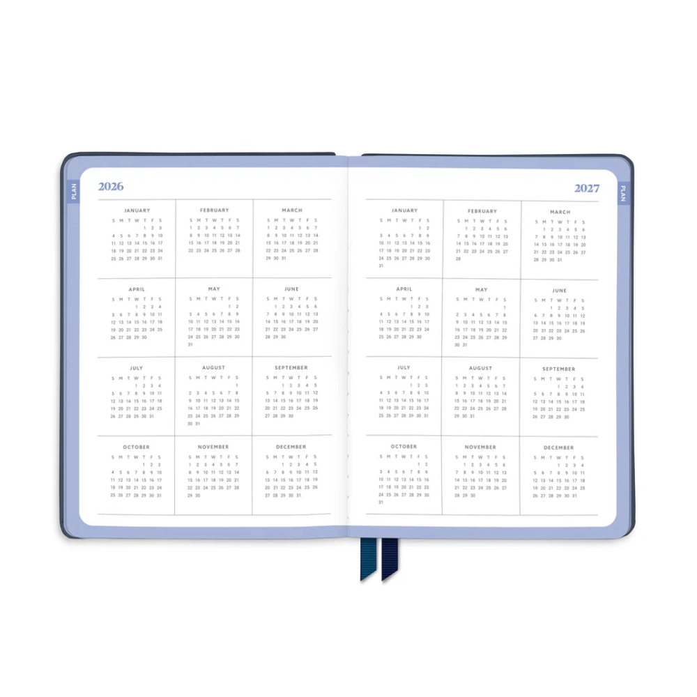 Open planner showing January 2023 calendar with a blue strap on a white background
