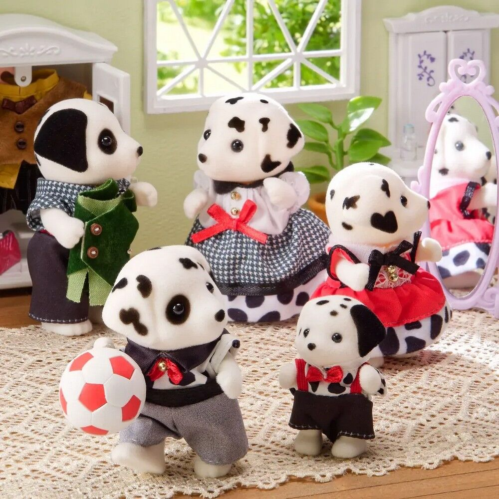 Set of Dalmatian-themed plush toys in various outfits on a textured surface.