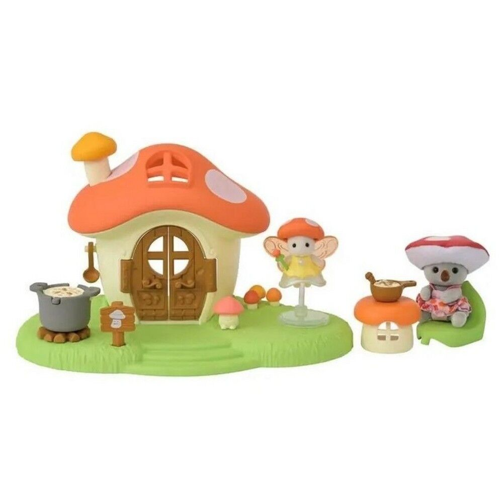 A small fairy-themed mushroom house playset with a mushroom-shaped cottage, green base, small figurines, and matching mushroom seating on a plain white background.