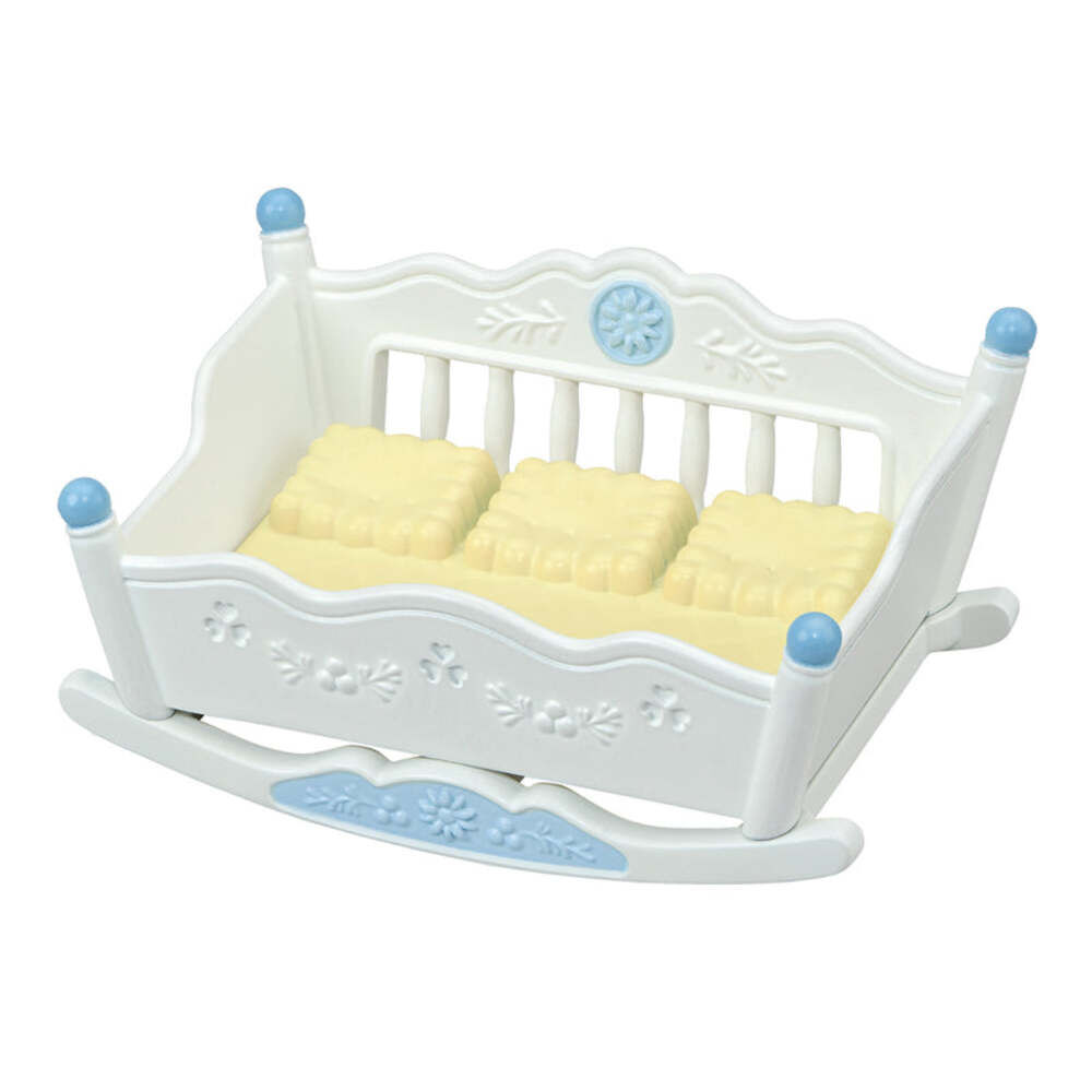 White rocking crib with yellow mattress on a white background