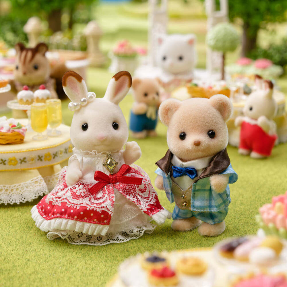 Plush toy rabbit and bear couple in a garden setting with other toys and food.
