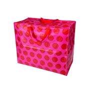 A large rectangular storage bin or bag with a shiny pink surface covered in large red polka dots, featuring two red top handles, shown on a plain white background.