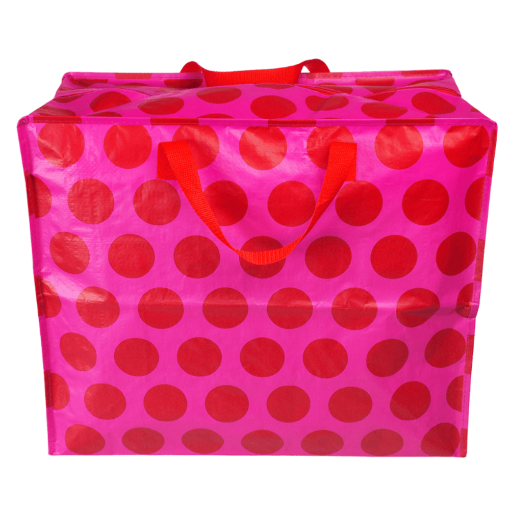 A large storage or utility bag with a vibrant pink and red polka dot pattern, featuring two red webbing handles, shown against a plain white background.