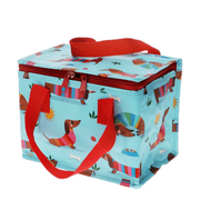 A light blue insulated lunch bag with a red handle and zipper, printed with cartoon dachshunds and colorful beach-style stripes, shown on a white background.