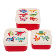 Three small square lunch boxes with red bodies and cream lids, decorated with colorful cartoon dinosaurs, shown on a white background.