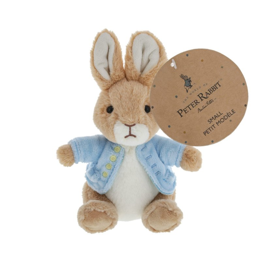 Plush toy rabbit with a blue sweater and tag on a white background