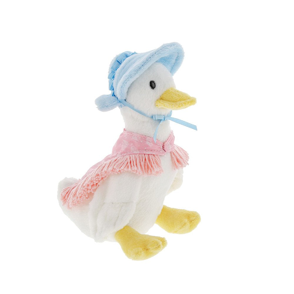Plush toy duck wearing a pink dress and blue bonnet on a white background