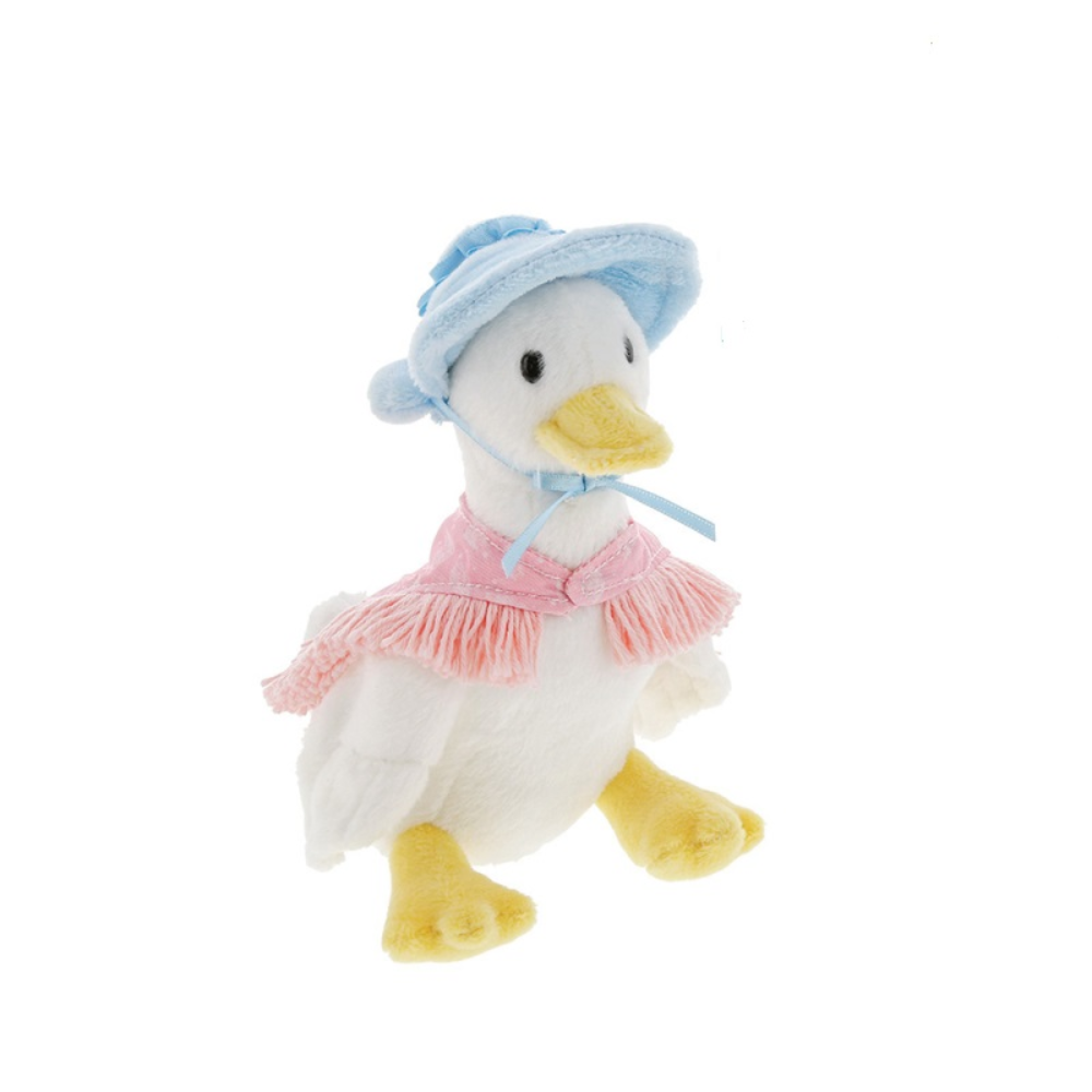 A plush toy duck wearing a light blue bonnet with a blue ribbon and a pink fringed top, standing against a plain white background.