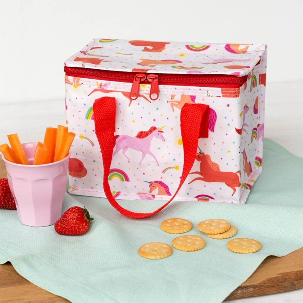 Children's lunch bag with unicorn design on a table with snacks