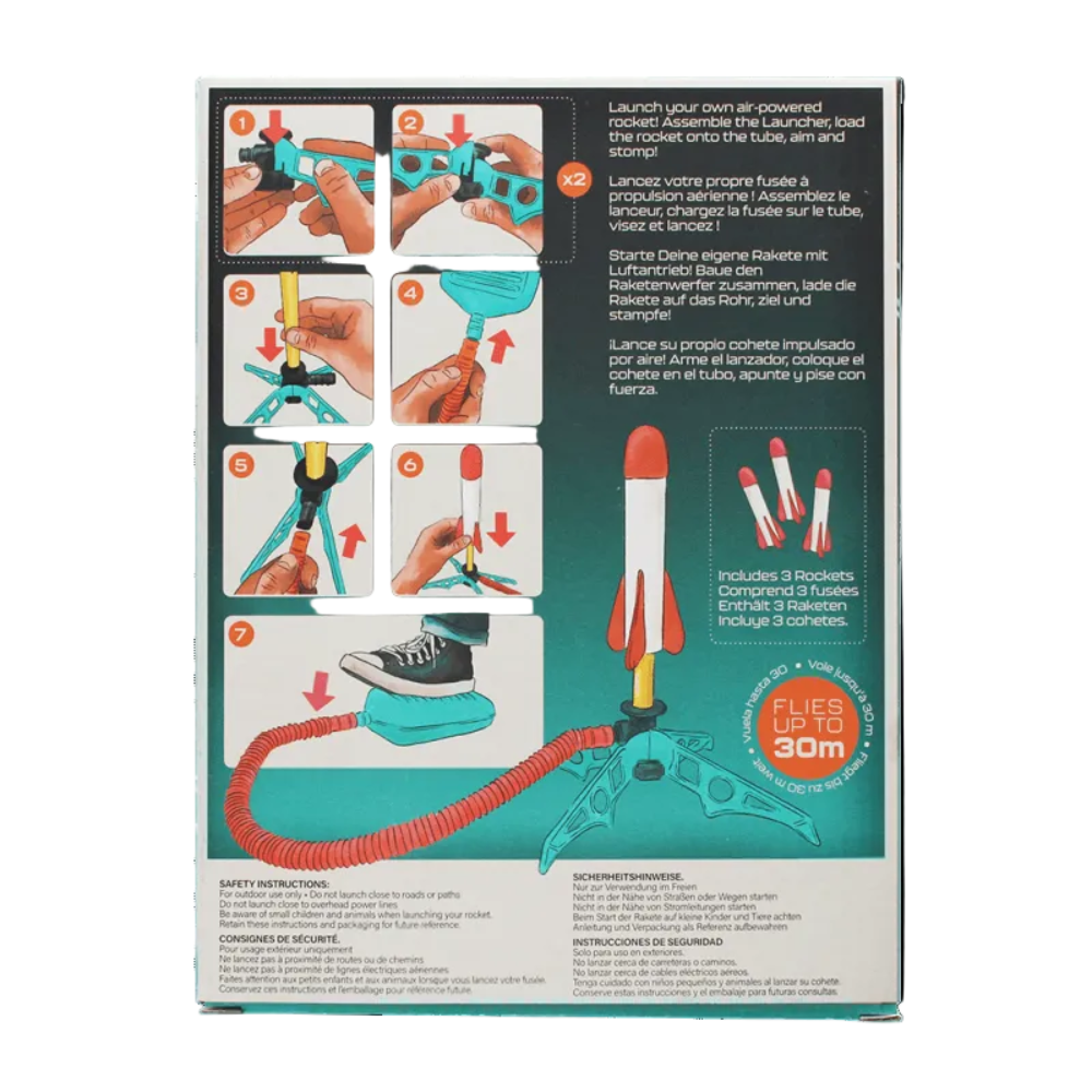 The back of a toy rocket packaging box, showing step-by-step assembly instructions in English, French, and Spanish, along with product details and a red circular badge that says 'FLIES HIGH 30m'.