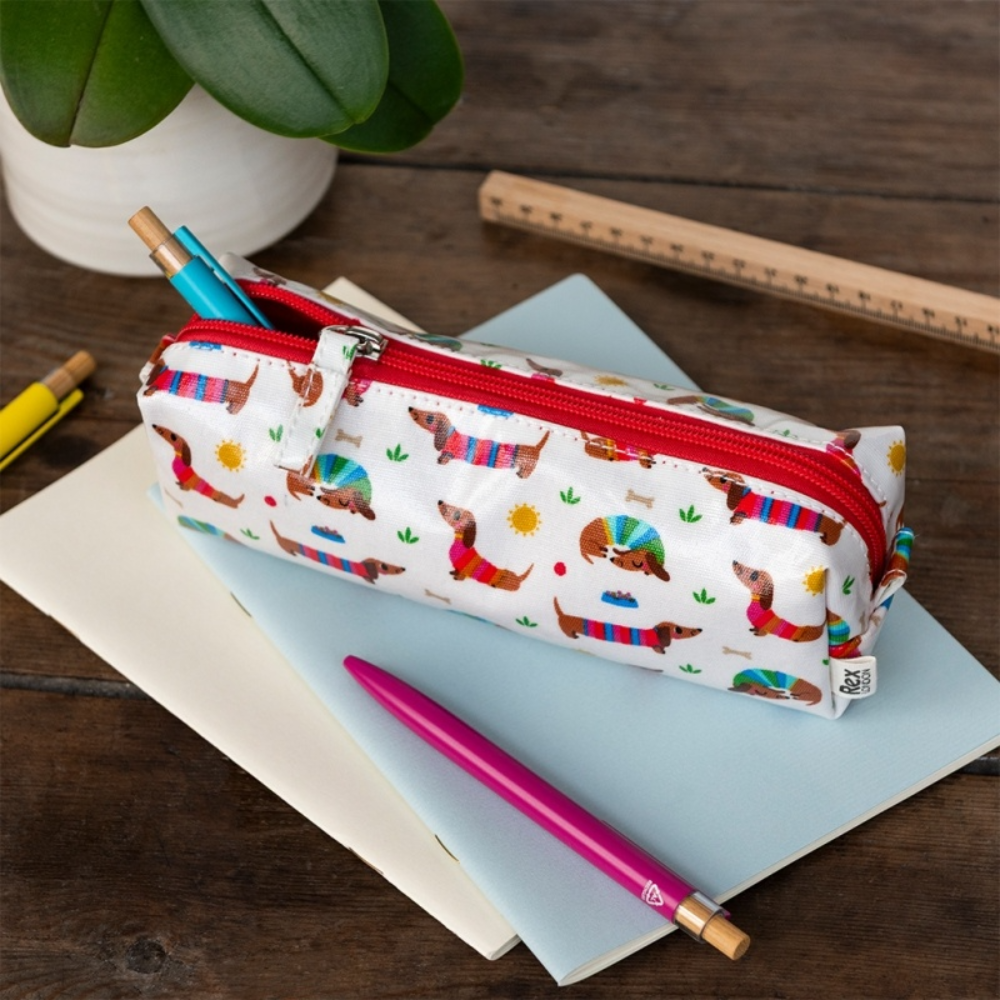 Pencil case with dachshund pattern on a wooden surface with stationery items