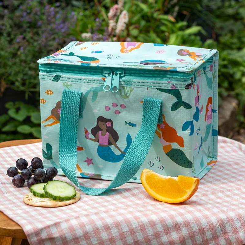 Colorful insulated lunch bag with mermaid design on a checkered tablecloth outdoors.