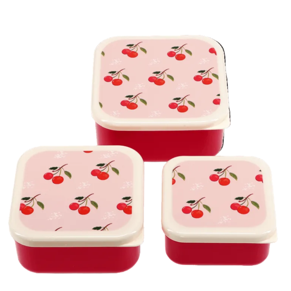 Three square lunch boxes with red bodies and light pink lids decorated with a cherry print, arranged on a white background.