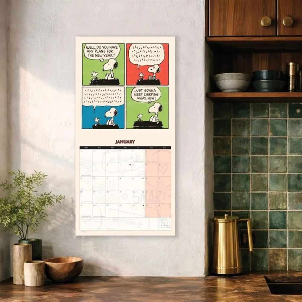 Calendar with comic design on a wall in a kitchen setting