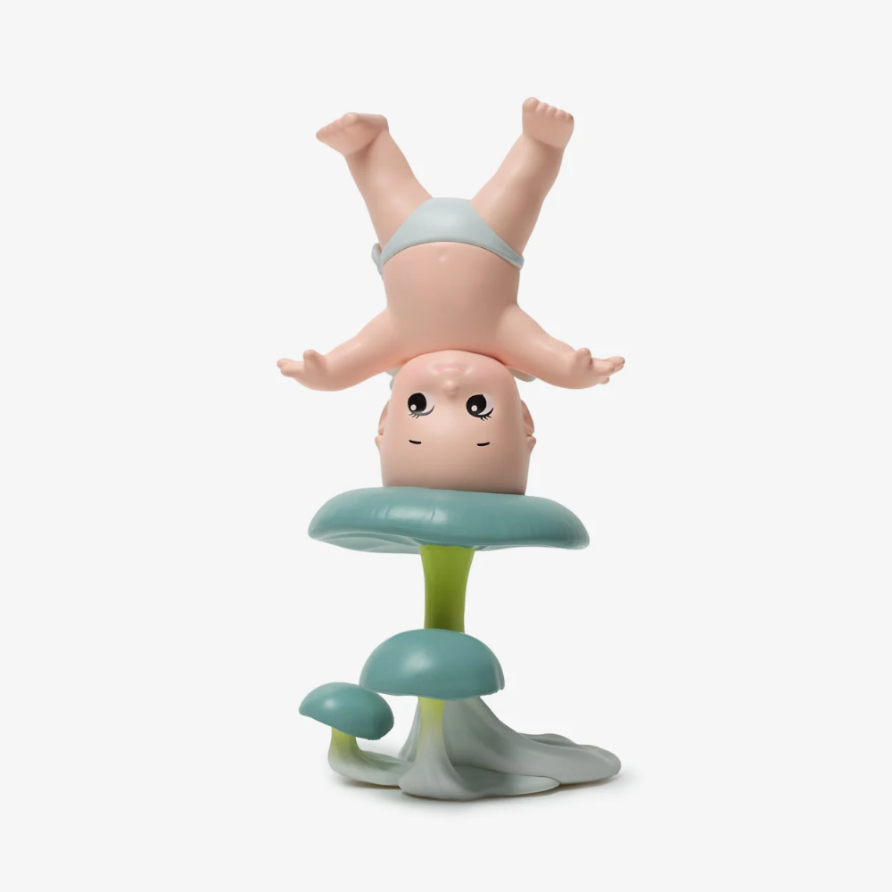 Baby teether with a small figure on top on a white background