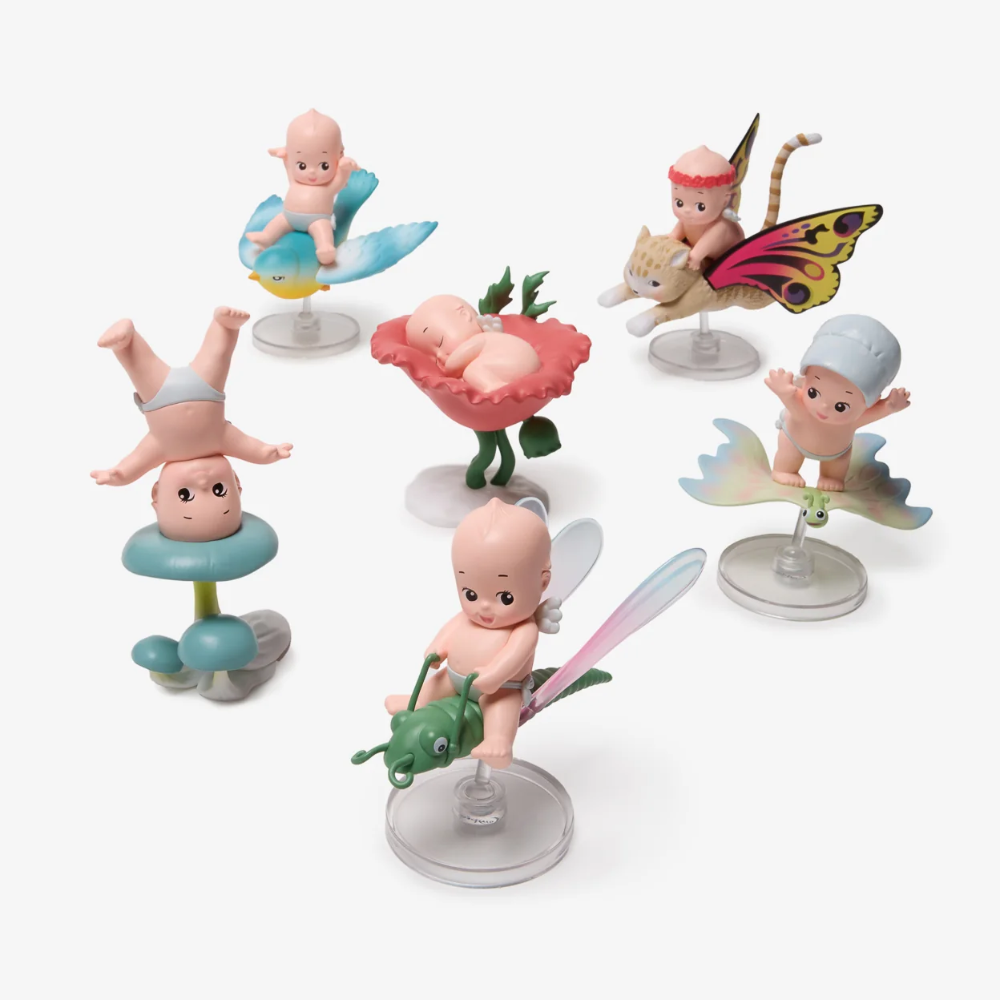 Set of small figurines on stands with a white background