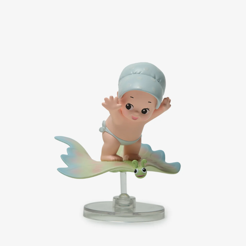 Figurine of a baby on a cloud with a white background