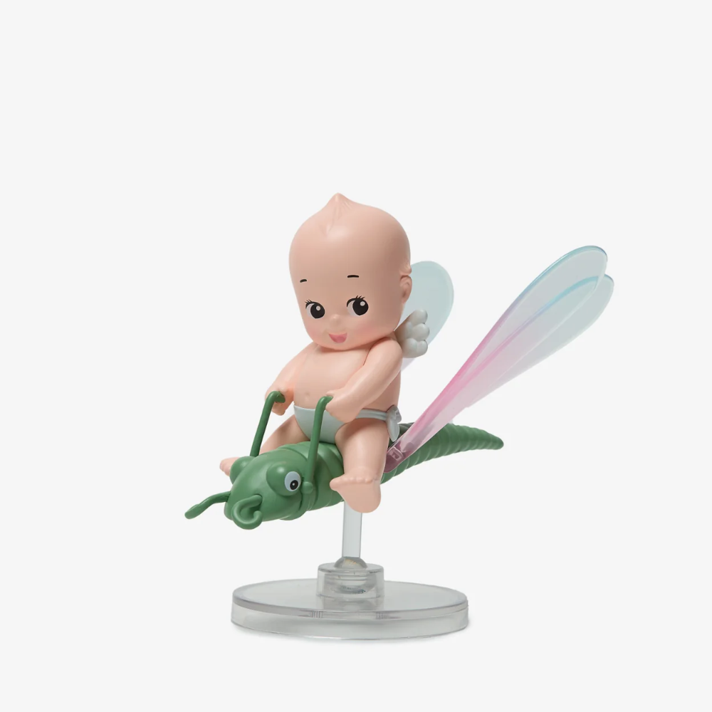 Figurine of a baby on a grasshopper with fairy wings on a white background