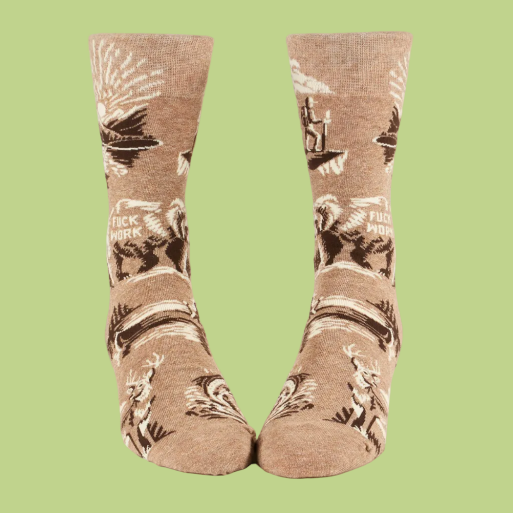 A pair of crew socks in a heathered tan color with a dark brown and cream graphic print of a wolf, a sunset, and the text 'FUCK WOLF'.