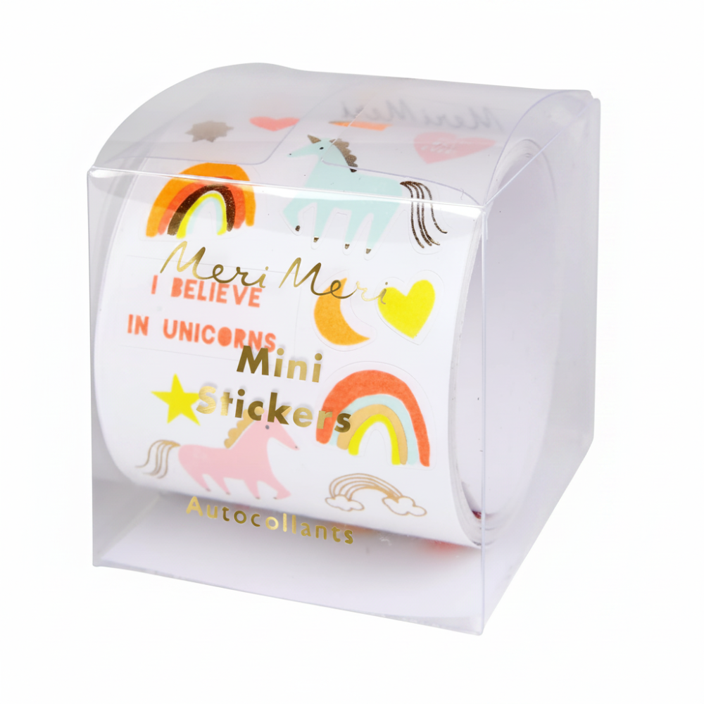 A roll of MeriMeri Mini Stickers in a clear plastic cube packaging, decorated with colorful unicorn, rainbow, moon, and heart designs on a white background.