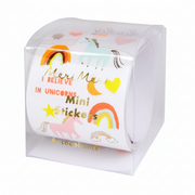 A roll of MeriMeri Mini Stickers in a clear plastic cube packaging, decorated with colorful unicorn, rainbow, moon, and heart designs on a white background.