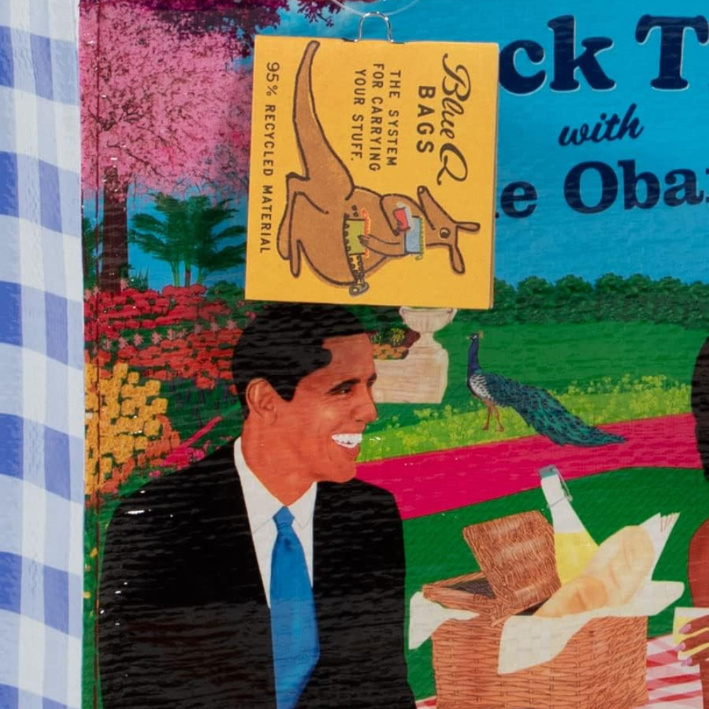 A colorful printed sign or label featuring a cartoon kangaroo wearing a harness and the text '95% Recycled Material' hanging in front of a bright illustrated background with a smiling man in a suit, flowers, trees, and a peacock.