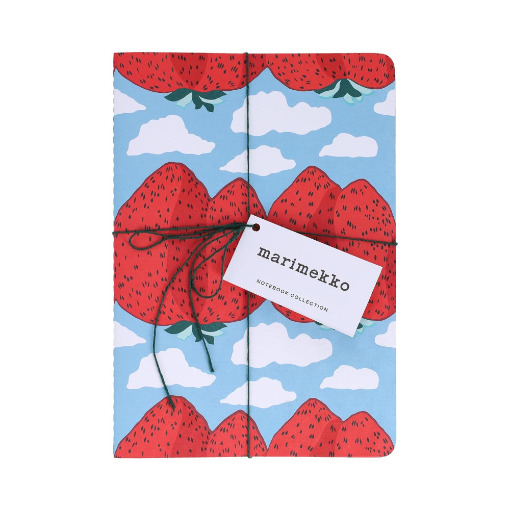 A notebook from the marimekko Nutribook Collection wrapped in a dark green string with a white paper tag. The cover features a playful pattern of red strawberries and white clouds on a light blue background.